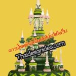 สถูปทรงหลายชั้นประดับด้วยเทียนสีขาว ดอกไม้สีชมพู และประดับด้วยลายทอไทยสีเขียวและเหลือง บนพื้นหลังสีเหลือง
